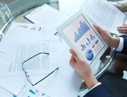 Businessman holding a tablet with statistical data