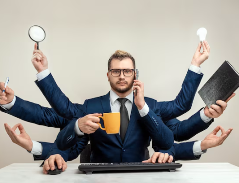 Businessman with many hands in a suit working with several objects at the same time