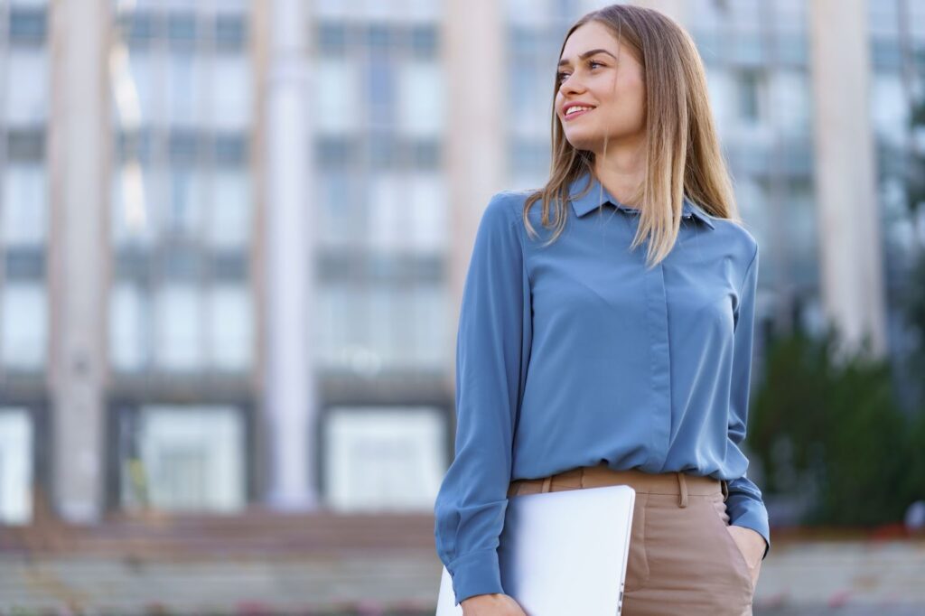 Woman wearing business casual clothes and holding paper