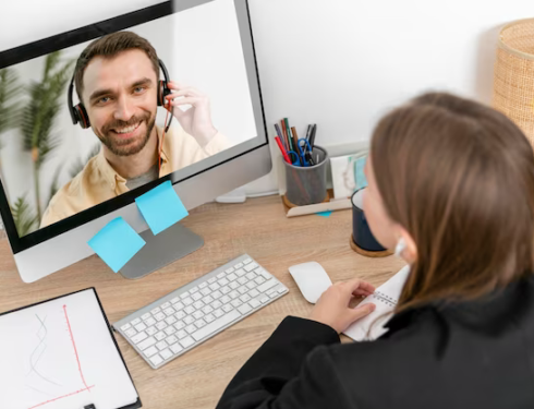 A woman communicates via video with a man